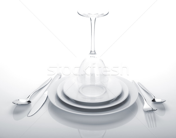Silverware or flatware set and wine glass over plates Stock photo © karandaev