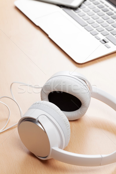 Headphones and laptop on wooden desk table Stock photo © karandaev