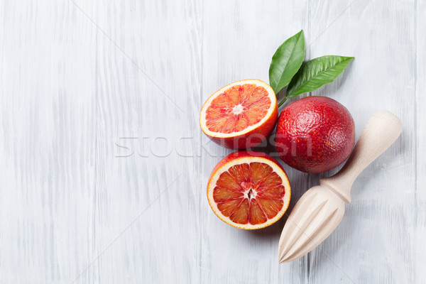 Fresh ripe red oranges and juicer Stock photo © karandaev