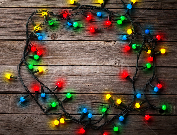 Christmas colorful lights over wooden background Stock photo © karandaev