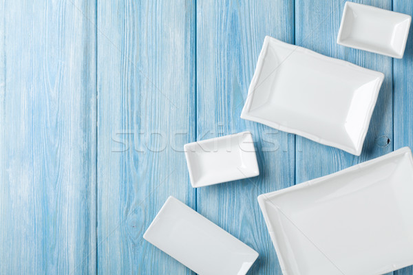 Stock photo: Empty plates and bowls on blue wooden background