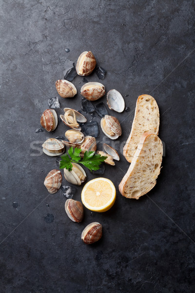 Fresh seafood on stone table. Scallops Stock photo © karandaev