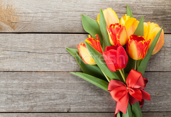 Fresh colorful tulips with ribbon and bow Stock photo © karandaev