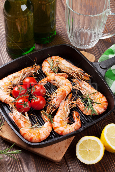 Grilled shrimps on frying pan and beer Stock photo © karandaev