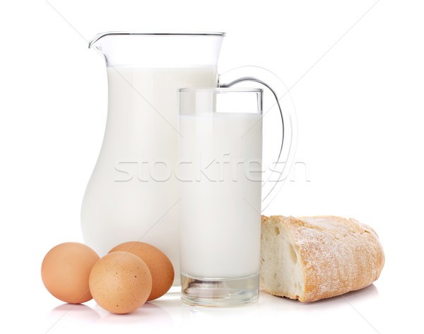 Milk jug, glass, eggs and bread Stock photo © karandaev