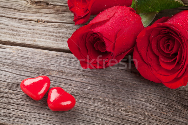 Red rose and candy hearts over wood Stock photo © karandaev