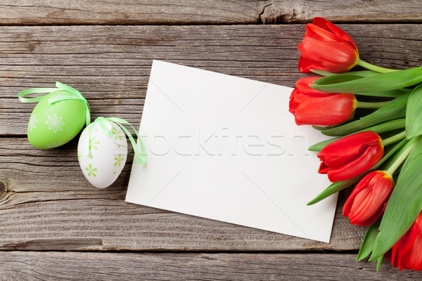 Easter eggs tulipani biglietto d'auguri tavolo in legno top view Foto d'archivio © karandaev