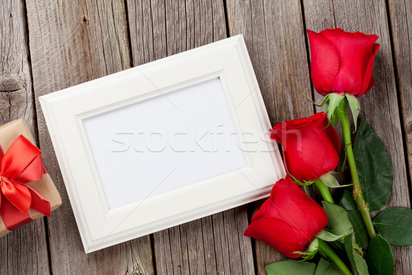 Red roses, photo frame and gift box Stock photo © karandaev