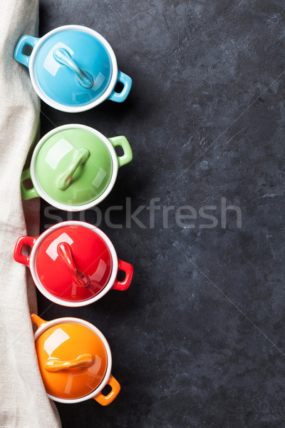 Colorful saucepans on stone Stock photo © karandaev