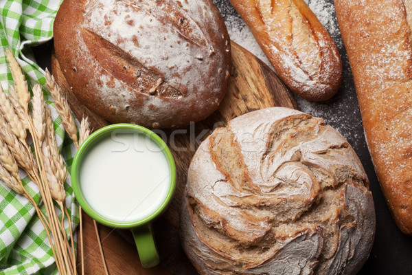 Various crusty bread and cup of milk Stock photo © karandaev
