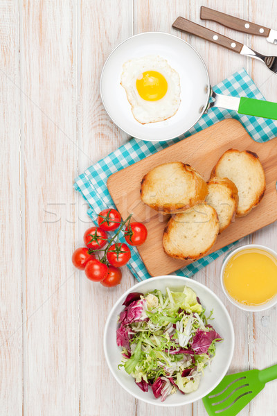 Healthy breakfast with fried egg, toasts and salad Stock photo © karandaev