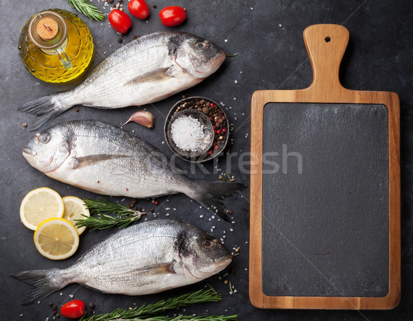 Brut poissons épices cuisson planche à découper haut [[stock_photo]] © karandaev