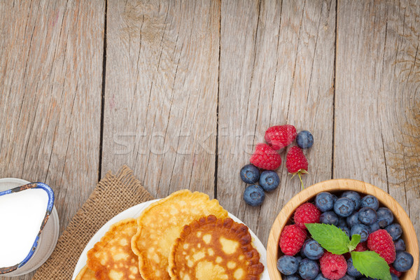 Pancakes with raspberry, blueberry and milk Stock photo © karandaev