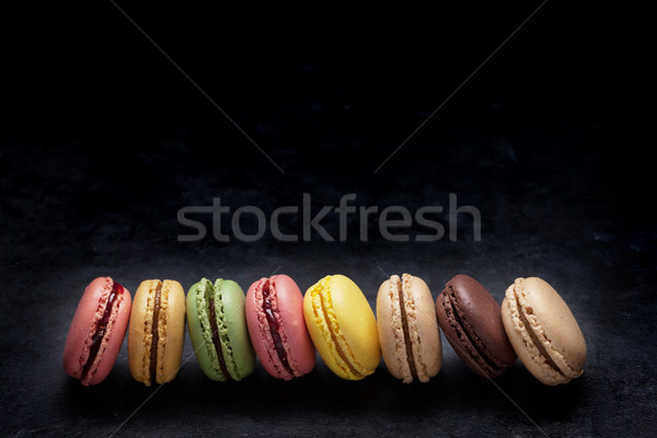 Colorful macaroons on stone table. Sweet macarons Stock photo © karandaev