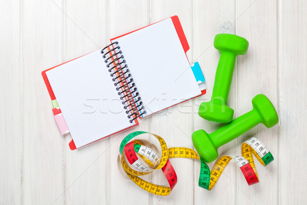 Dumbells, tape measure and notepad for copy space Stock photo © karandaev