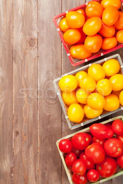 Colorful tomatoes on wooden table Stock photo © karandaev