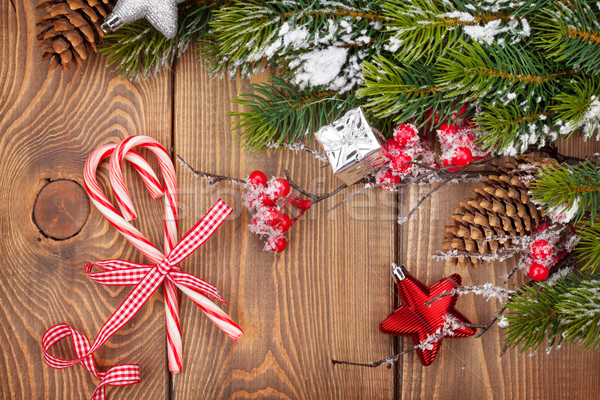 Stock photo: Christmas wooden background with decor, candy canes and snow fir