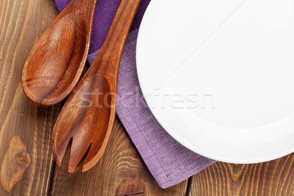Wood kitchen utensils and empty plate Stock photo © karandaev