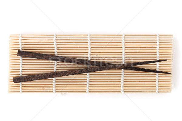 Stock photo: Chopsticks over bamboo mat