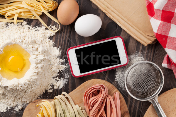 Table de cuisine smartphone ustensiles ingrédients écran haut [[stock_photo]] © karandaev