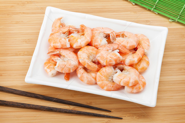 Cooked shrimps and chopsticks Stock photo © karandaev