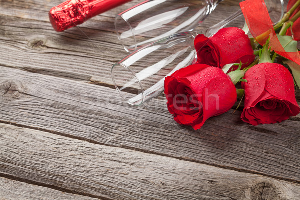 Red roses and champagne Stock photo © karandaev