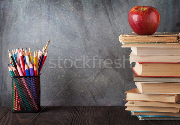 Books and supplies in front of chalk board Stock photo © karandaev