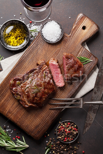 Grilled ribeye beef steak with red wine, herbs and spices Stock photo © karandaev