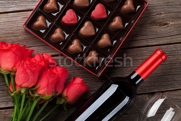 Valentines day with red roses, wine and chocolate Stock photo © karandaev
