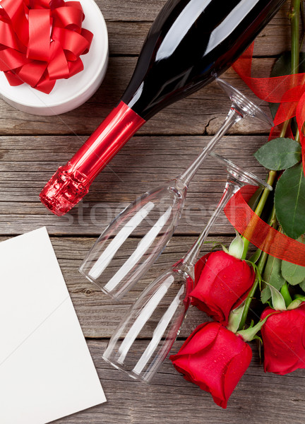 Red roses, champagne and greeting card Stock photo © karandaev