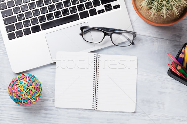 Desk table with laptop and notepad Stock photo © karandaev
