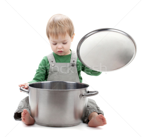 Baby looking inside saucepan Stock photo © karandaev