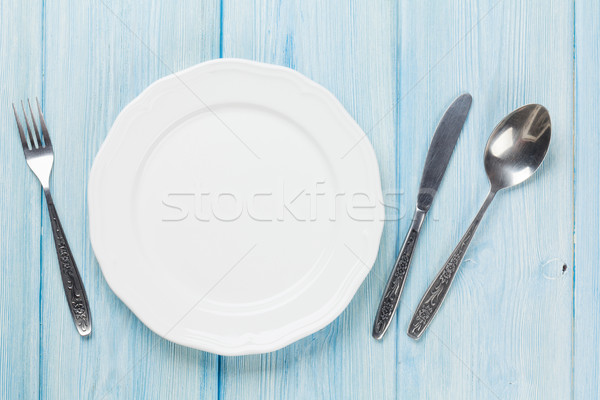 üres tányér ezüst étkészlet fa asztal felülnézet copy space Stock fotó © karandaev