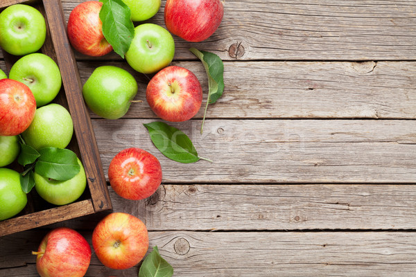 Green and red apples in wooden box Stock photo © karandaev