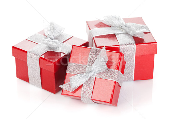 Three red gift boxes with silver ribbon and bow Stock photo © karandaev
