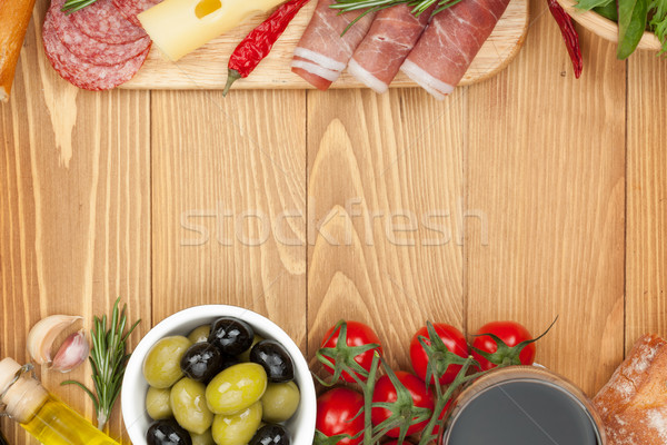 Stock photo: Red wine with cheese, olives, tomatoes, prosciutto, bread and sp