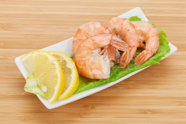 Cooked shrimps with lemon and salad leaves Stock photo © karandaev