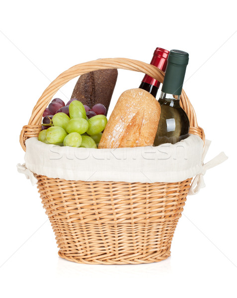 Picnic basket with bread, cheese, grape and wine bottles Stock photo © karandaev