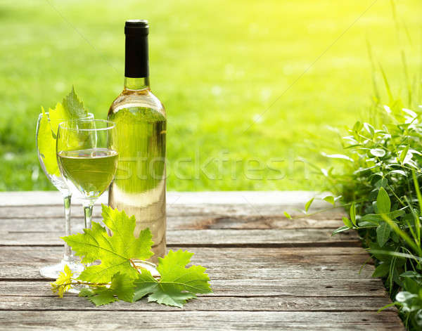 Beyaz şarap şişesi cam ahşap masa açık natürmort uzay Stok fotoğraf © karandaev