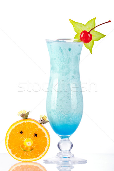 Blue tropical cocktail with coconut cream and orange face Stock photo © karandaev