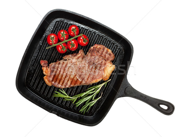 Sirloin steak with rosemary and cherry tomatoes cooking in a fry Stock photo © karandaev