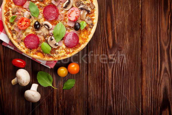 Stock photo: Italian pizza with pepperoni, tomatoes, olives and basil