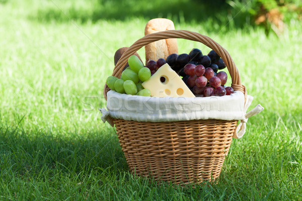 Outdoor picnic basket on green lawn Stock photo © karandaev