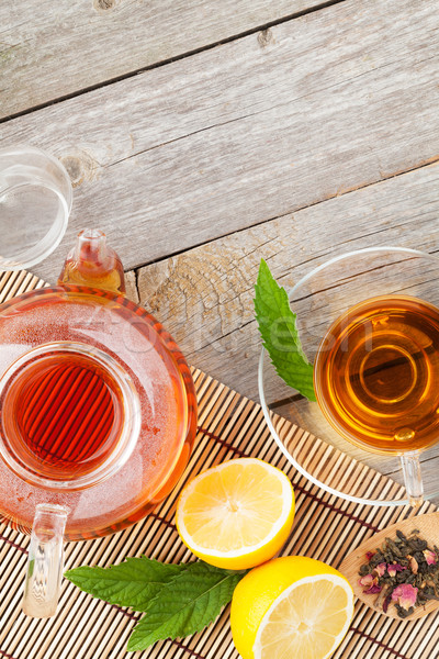 Green tea with lemon and mint on wooden table Stock photo © karandaev