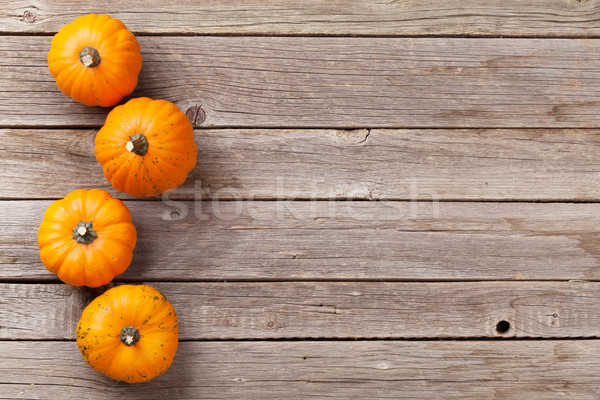 Stock photo: Autumn pumpkins on wooden board table