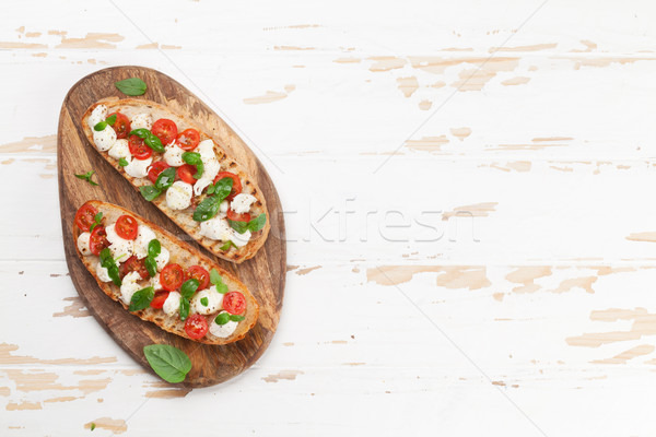 Caprese bruschetta kiraz domates mozzarella fesleğen üst Stok fotoğraf © karandaev