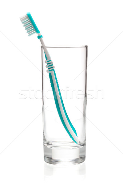 Green tooth brush in glass Stock photo © karandaev