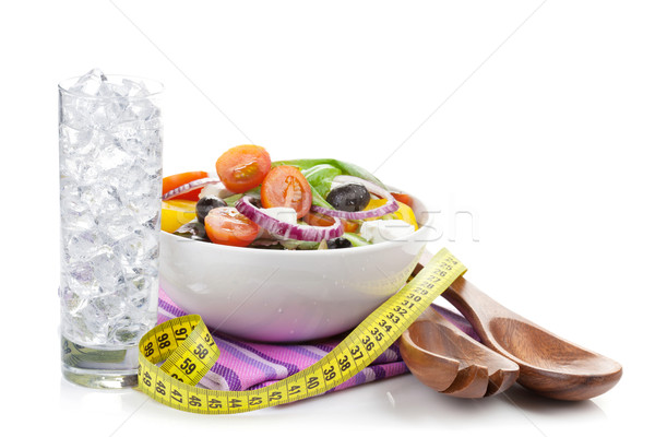Fresh healthy salad, glass of water and kitchen utensil Stock photo © karandaev