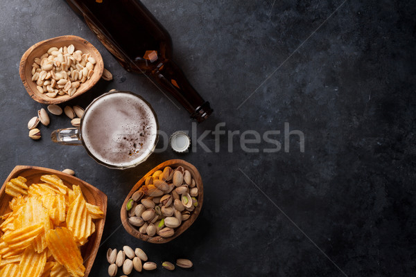 Lager beer and snacks on stone table Stock photo © karandaev