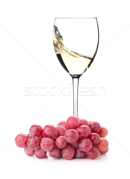 Splashing white wine in a glass and grapes Stock photo © karandaev